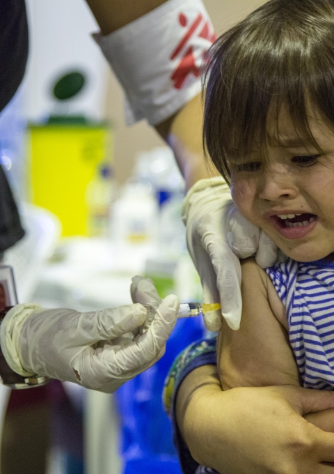 Young girl receiving vaccine.
