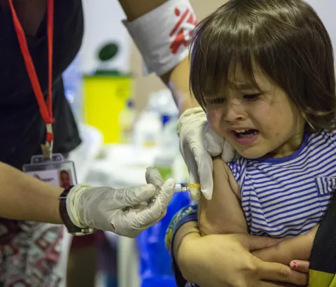 Young girl receiving vaccine.